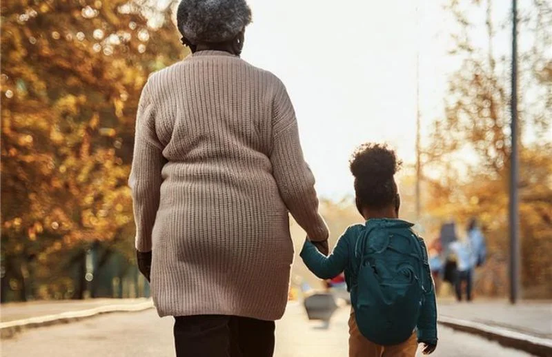 Elder woman and child walking